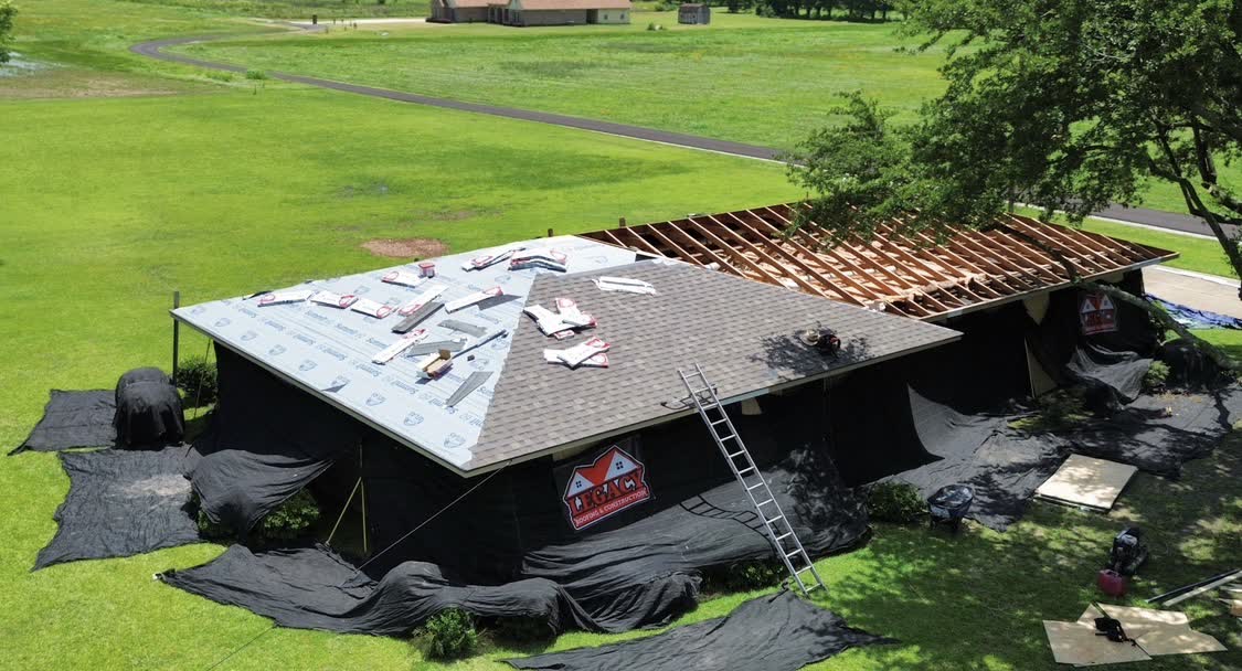 Legacy Roofing & Construction yard sign at an active Central Mississippi job site